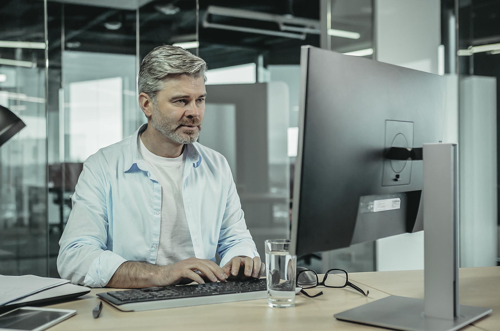 Middle-aged people working with E-Learning on computer.