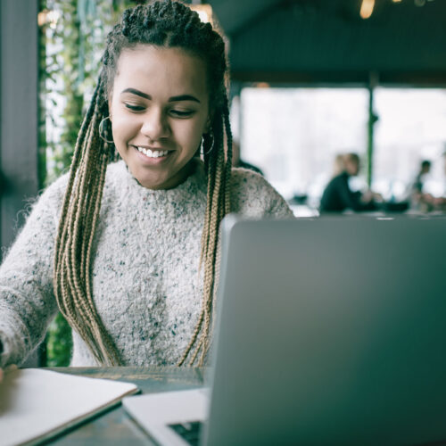 Young woman sitting at a computer using E-Learning