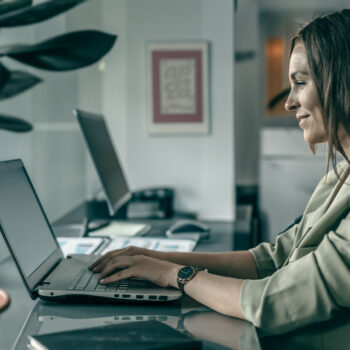 Female working with System Training and E-Learning on laptop.