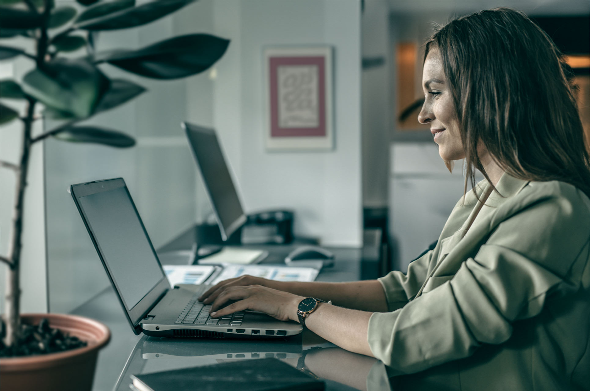 Female working with System Training and E-Learning on laptop.
