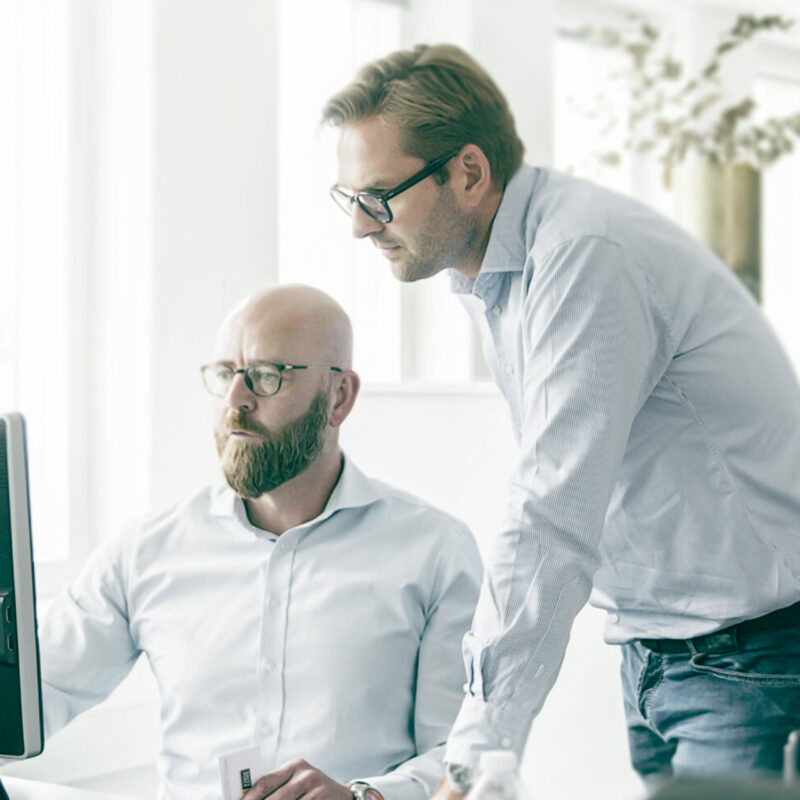 Manager helping colleague reviewing sales pitch